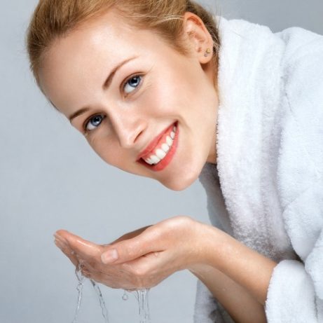 Young woman washing face